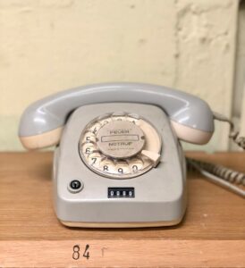 Photo by Eckhard Hoehmann gray rotary telephone on brown table